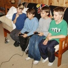 Gavin, Nick B, Adam and Sam playing Playstation.