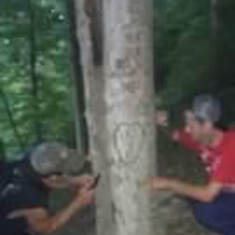 Eric and Adam carving our names in the tree