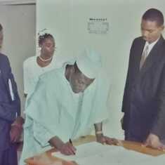 Daddy endorsing the church wedding certificate of his first son, Pastor Adeola.