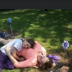Holley and Lydia laying on grandpa’s grave