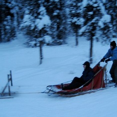 2009: Al on the sled runners, and Paul is in the sled. Dog sledding in Alaska.