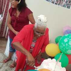 Mama cutting her cake at her 90th birthday celebration.