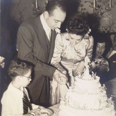 Cutting the cake, with an impatient Peter Ascoli looking on.