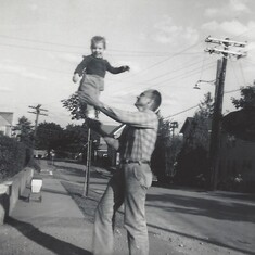 Judy's not afraid of heights if her Daddy is holding her up!
