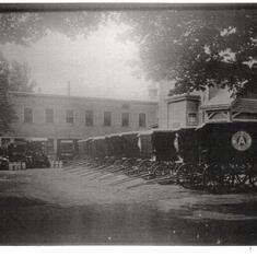 The horse drawn milk wagons in front of Andrews' Dairy next to Allen's
