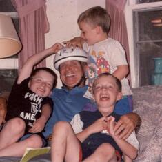 Patti's sons, Paul, Scott & Greg getting goofy with Grampie in his new bike helmet.