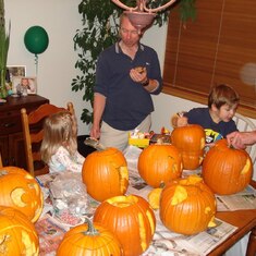 Drew being told the right way to carve a pumpkin by Sophie.