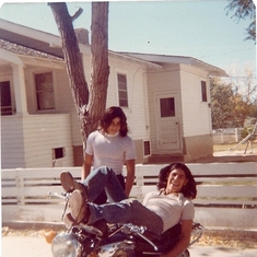 Val Aguilar,Andy montoya laying on the motor cycle