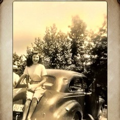 Mom sitting on the back of Dad's car.  Gorgeous!