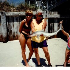 AK holding a dead shark in Myrtle Beach with April