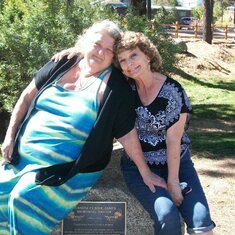 Debby and Paula sitting on the memorial for their grandmother Juanita C. Janes which Arline worked so hard to restore.