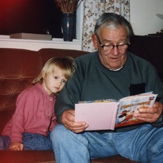 Art reading to his granddaughter, Leana.