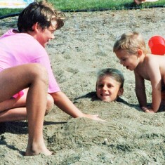 Arvin's oldest 3 grandchildren - cousins Audra and Sam burying Erik at the lake home.