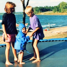Arvin's grandchildren - cousins Audra, Sam & Erik - jumping on a neighbor's trampoline at the lake (1991).