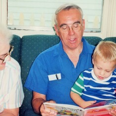Arvin reading to grandson, Sam (1991), with his mother, Hazel (Drinkwine) Hagen, watching at daughter, Cindy's, home in St. Paul.