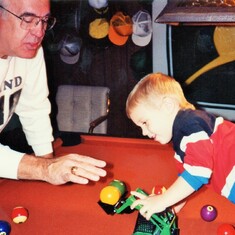 Arvin playing with grandson, Sam, on the pool table in his basement in Coal Valley, IL.