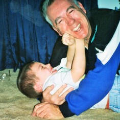 Arvin wrestling with grandson, Sam Lukas.