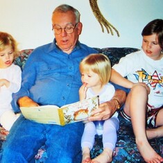 Arvin reading to son Brent Hagen's daughters at his Fargo townhome:  Cassie, Amanda & Emily (April 2003).
