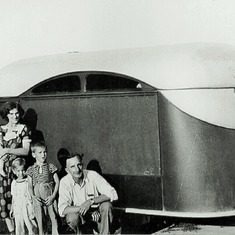 Hazel and Adolph Hagen and their three boys -  Charles, Alden and Arvin - by the pull-behind trailer they used to move to Portland, OR, and then CA (1941).