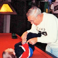 Arvin tickling Sam on his pool table (1992).  They both had fun.