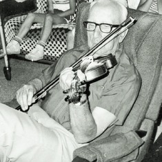 Adolph playing violin.  He played at dances, which was a mixed blessing.  His wife couldn't dance if he was playing!