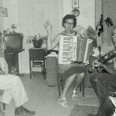 Making music together.  Arvin's aunt, Mabel, her husband, Carl, on banjo, and Arvin's dad, Adolph on violin.  It was always a lot of fun hearing them play.  It helped that they were all good musicians and enjoyed themselves, too.