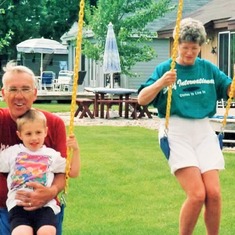 Arvin & Bev swinging with Sam at the lake (1994).