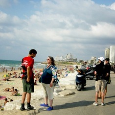 Barry and Jared on beach walk, Tel Aviv. Note guy in red shirt carrying Uzi machine gun. 2009