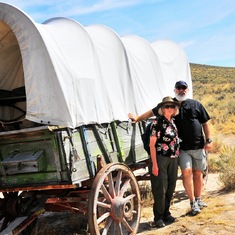 Ev and Barry beside the covered wagon on the Oregon Trail exhibit in Eastern Oregon Sept 2008