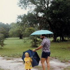 Aaron and Barry in rain on the driveway of our house on Sapelo 1985