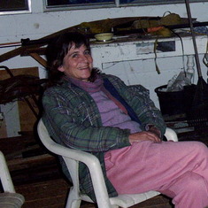 Sue relaxing after a full day of planting trees at her friend Bruce's property. May 2003.
