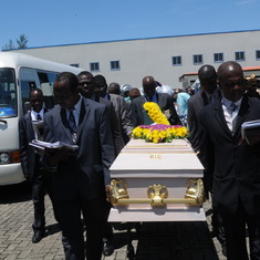 Dad's mortal remains being taken to the interment grounds by the pastors