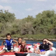 Nana with the great grandkids behind the boat