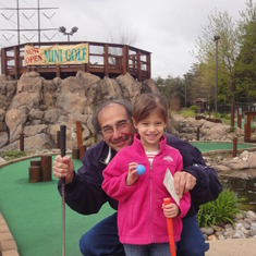 Grandpa taking Sarah for her first golf lesson.