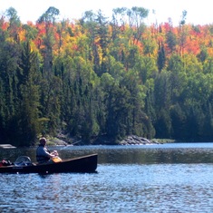 Quetico: Bill paddling, George doing nothing. 