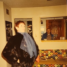 Billie Joan Buller, in faux fur coat, and wearing one of her prized scarves. Hurley is also seen.