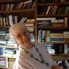 Billie Joan Buller, wearing a beaded necklace she herself made and designed, with her book case 2009