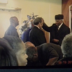 Bishop Tyler prays for men at Olive Grove COGIC
