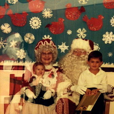 Blake and Amanda with Santa. (Look at the crazy "other" Santa in the photo!!)