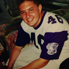 Blake wearing his dad's football jersey from Northwestern University.