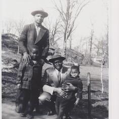 Robert as a young child with his brother Freeman, dad Robert Sr. and friend