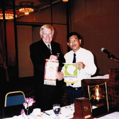 Bob at the Singapore Rotary, exchanging Club Flags