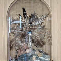 One of Bonnie's beautiful creations, with feathers, rocks, shells found on her epic walks in Rocklin