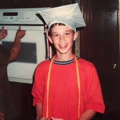 Brad trying on Dana's high school graduation cap and tassels, May 2000