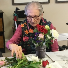 Creating her weekly bouquet
