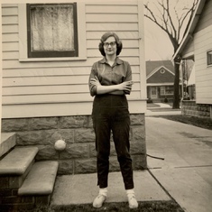 Looking cool in her cigarette pants at the back of her parents home