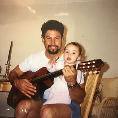 Carl loved to share his love of music with the kids. Here he is with Jessica.