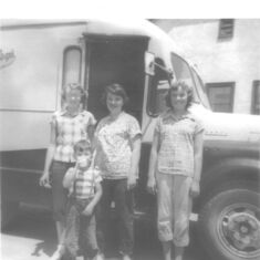 Carol and cousins in front of the dairy milk truck