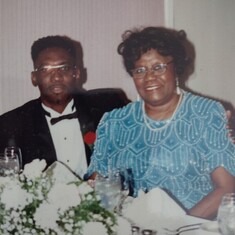 Congresswoman Carrie P. Meek with a young Rev. Baxter in 1999.