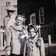 Mom and her little sis Barbara pose in their Easter finest in Highlandtown, while a dapper Pop looks on from behind.